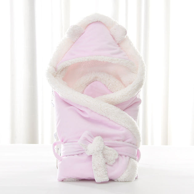 Newborn baby being hugged and swaddled by baby - Health and Wellness Innovations