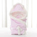 Newborn baby being hugged and swaddled by baby - Health and Wellness Innovations