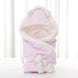 Newborn baby being hugged and swaddled by baby - Health and Wellness Innovations